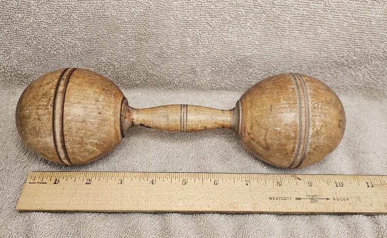 A fabulous pair of antique wooden exercise / juggling clubs