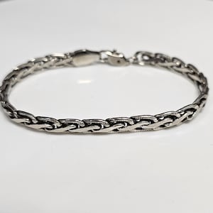 Very pretty, nice condition braided twist bracelet! Marked.925 sterling silver!
