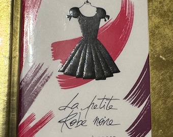 May include: A white box with a red and purple background. The box features a black and silver illustration of a little black dress. The text on the box reads "Guerlain La petite Robe noire Ma Première Robe Eau de Parfum - Limited Edition 50 ml 1.6 FL. OZ."