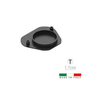 May include: A black, geometric-shaped product with a circular indentation and two small cylindrical protrusions. The product has a matte finish and is likely made of plastic or metal. The text "T Print" and "MADE IN ITALY" are also visible.