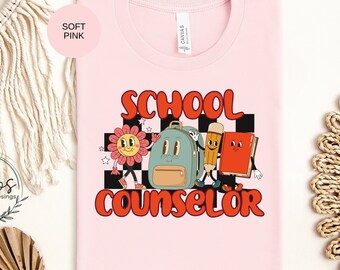 May include: A soft pink t-shirt with a graphic design of a smiling flower, backpack, pencil, and book with the text "School Counselor".