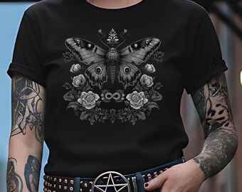 May include: Black t-shirt featuring a detailed grayscale illustration of a moth with floral accents and an infinity symbol. The design is centered on the shirt. The person is wearing a belt with a pentagram buckle.