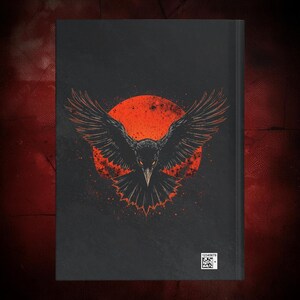 May include: Black journal featuring a detailed illustration of a raven with outstretched wings against a red sun. The raven's eyes glow, and the background has a speckled effect. A small barcode is visible at the bottom.