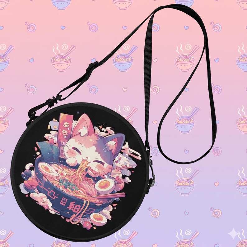 May include: Black round crossbody bag featuring a colorful anime-style illustration of a cat eating ramen. The bag has a black adjustable strap and a repeating pattern of ramen bowls on a pink and purple background.