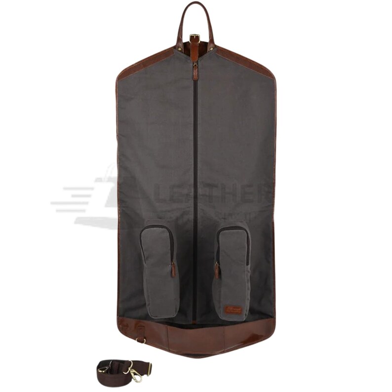 May include: A gray garment bag with brown leather trim and two zippered pockets. The bag has a shoulder strap and a zipper closure.