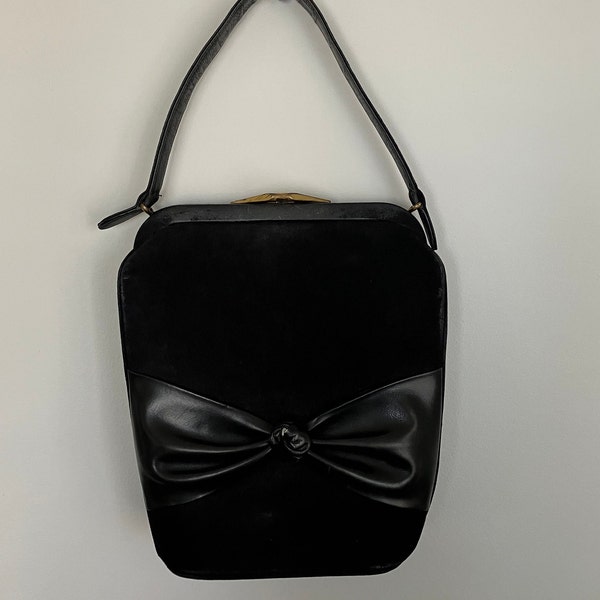 Vintage black suede, suede like purse, handbag, 1940s or 50s with wide bow across front, short handle, metal frame, and gold snap clasp.