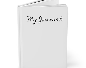 May include: A white journal with the words "My Journal" written in black ink on the front cover.