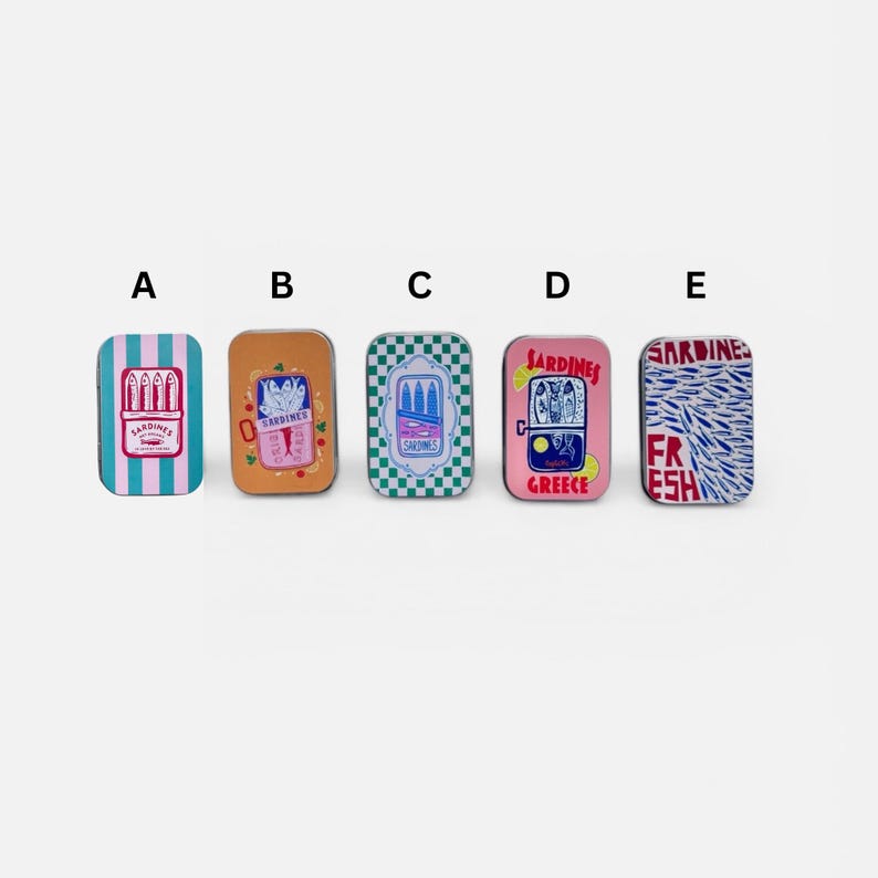 May include: Five rectangular metal tins labeled A through E, each featuring unique sardine-themed illustrations. Designs include blue stripes, orange with fish, green checkerboard, pink with lemon slices, and a dense pattern of blue fish with red text.
