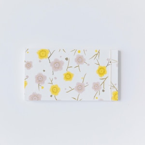 May include: A rectangular, floral-patterned notepad with a white background. The design features yellow and pink flowers with brown stems. A string binds the notepad together on the right side.