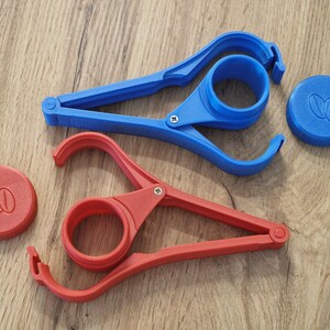 May include: Two plastic jar openers, one blue and one red, with a lid for each. The lids have a coffee bean design.