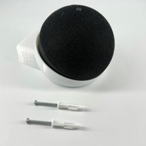 May include: White wall mount for a black round smart speaker with two white screws.
