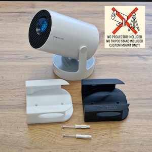 May include: A white projector with a black front and a blue lens, on a white stand. Two custom mounts, one white and one black, are shown below, with screws. The image text reads "NO PROJECTOR INCLUDED, CUSTOM MOUNT ONLY!"