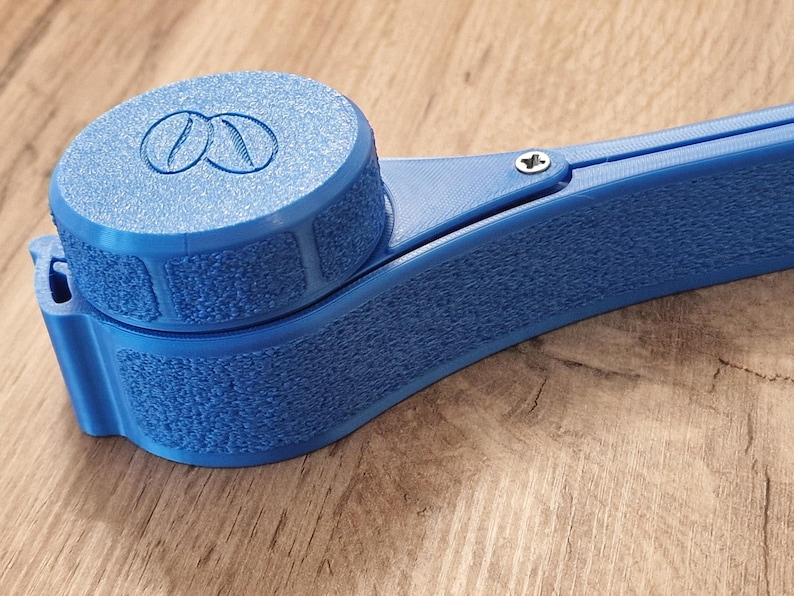 May include: A blue plastic coffee bean grinder with a textured surface and a screw on the side.