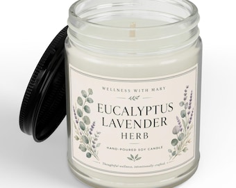 May include: A clear glass jar candle with a black lid, filled with white wax. The label features the text "Wellness with Mary," "Eucalyptus Lavender Herb," and "Hand-poured soy candle," decorated with watercolor illustrations of eucalyptus and lavender.