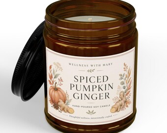 May include: A brown glass jar candle with a black lid and a cream-colored label. The label features the text "WELLNESS WITH MARY," "SPICED PUMPKIN GINGER," and "HAND-POURED SOY CANDLE," decorated with illustrations of a pumpkin, ginger, and foliage.