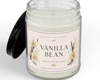May include: A clear glass jar candle with a black lid, filled with white wax. The label features the text "WELLNESS WITH MARY", "VANILLA BEAN", and "HAND-POURED SOY CANDLE" with illustrations of vanilla flowers and beans on a cream background.