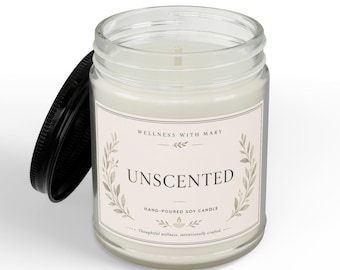May include: A clear glass jar candle with a white soy wax fill and a single cotton wick. The label features the text Wellness With Mary, Unscented, and Hand-Poured Soy Candle, framed by botanical illustrations. A black metal lid rests beside the jar.
