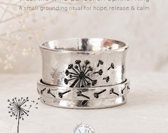 May include: A silver-toned spinner ring featuring a hammered texture and a black engraved dandelion design with seeds blowing in the wind. The text Trust the Wind Dandelion Spinner Ring and A small grounding ritual for hope, release & calm is visible.