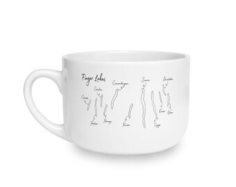 May include: A white ceramic mug featuring a black line art map of the Finger Lakes region. The design includes the text Finger Lakes and labels for individual lakes including Conesus, Hemlock, Canadice, Honeoye, Canandaigua, Keuka, Seneca, Cayuga, Owasco, Skaneateles, and Otisco.
