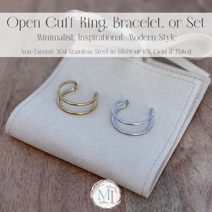 May include: Two open cuff rings, one gold-toned and one silver-toned, displayed on a neutral-colored cloth. The rings have a minimalist, modern design. Text at the top reads "Open Cuff Ring, Bracelet, or Set".