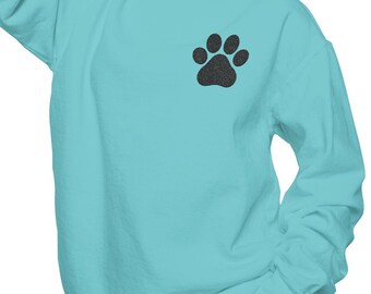 May include: A turquoise blue sweatshirt with a black paw print on the left chest.