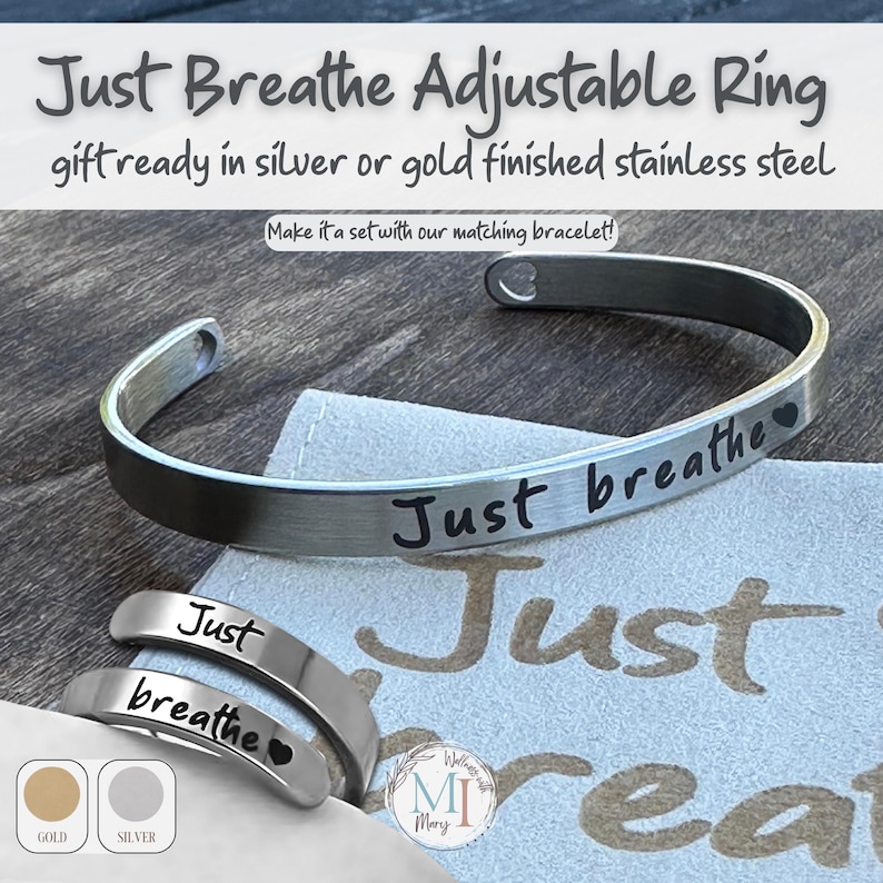 May include: A silver stainless steel adjustable ring and bracelet set with the words "Just breathe" engraved on them. The image also shows a small pouch and the words "Just breathe" in a larger font. The ring is available in gold or silver.