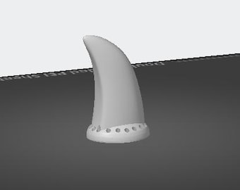 May include: A white plastic fin with a rounded tip and a base with small holes. The fin is designed for a surfboard or other water sport.