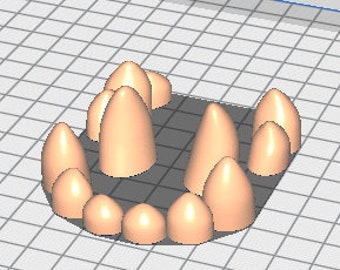 May include: A set of 14 sharp, pointed teeth made of a light brown material. The teeth are arranged in a curved shape, resembling a mouth.