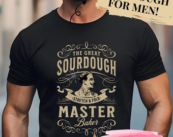 May include: A black t-shirt with a vintage-style graphic design featuring a man with a mustache and the text "The Great Sourdough - Stretch & Fold - Master Baker".