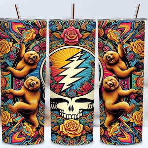 May include: A stainless steel tumbler with a colorful design featuring a skull with lightning bolts, bears, and flowers. The design is reminiscent of the Grateful Dead.