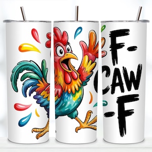 May include: A white cylindrical tumbler with a metal straw featuring a colourful cartoon rooster with red, yellow, and blue feathers. The design includes scattered paint-like droplets and the black text F-CAW-F printed vertically on the side.