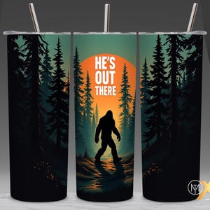 May include: A stainless steel tumbler with a black and green forest scene and a silhouette of Bigfoot. The text "He's Out There" is printed on the tumbler.