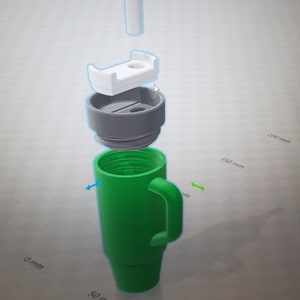 May include: A green travel mug with a handle and a white lid. The mug is disassembled to show the different parts. The mug is 150 mm tall and 50 mm wide.