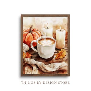 May include: A watercolor painting of a cozy autumn scene with a cup of coffee, a pumpkin, and two candles. The coffee has a white foam design on top and steam rising from it. The pumpkin is orange and has a green stem. The candles are white and are lit. The scene is set on a wooden table with a brown and white knitted blanket.