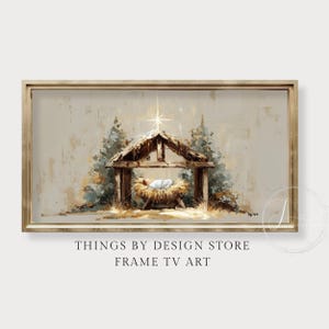 Puede incluir: Una impresión artística digital enmarcada que representa una escena de la Natividad. La obra de arte presenta un bebé en un pesebre, una estrella y una estructura de madera rústica. La paleta de colores incluye beige, marrón y toques de azul y verde.