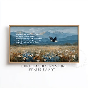May include: Framed art print featuring a landscape with mountains, a field of flowers, and an eagle in flight. The artwork includes a quote from Isaiah 40:31. The frame is a light brown color, and the text "THINGS BY DESIGN STORE FRAME TV ART" is at the bottom.