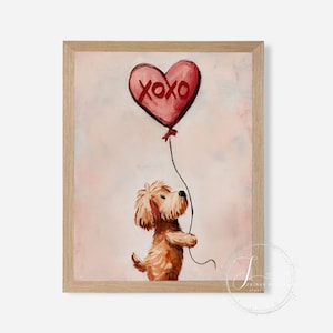 May include: A framed print of a brown dog holding a red heart-shaped balloon. The balloon has the letters "XOXO" on it. The background is a soft pink and white. The frame is light brown. A charming piece of art.