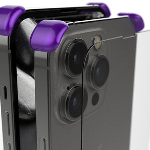 May include: A black smartphone with a clear case and purple corner bumpers. The phone has a triple camera system on the back.
