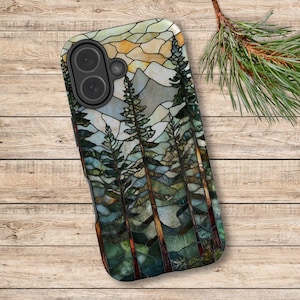 May include: A phone case featuring a stained-glass design of a mountain landscape with tall pine trees. The case has a black camera module and a colorful mosaic of blues, greens, and yellows, evoking a natural scene.