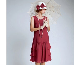 May include: A burgundy flapper dress with a tiered skirt, paired with a white hat adorned with a burgundy bow. The ensemble includes a pearl necklace, lace gloves, and a vintage lace parasol, evoking a classic 1920s style.