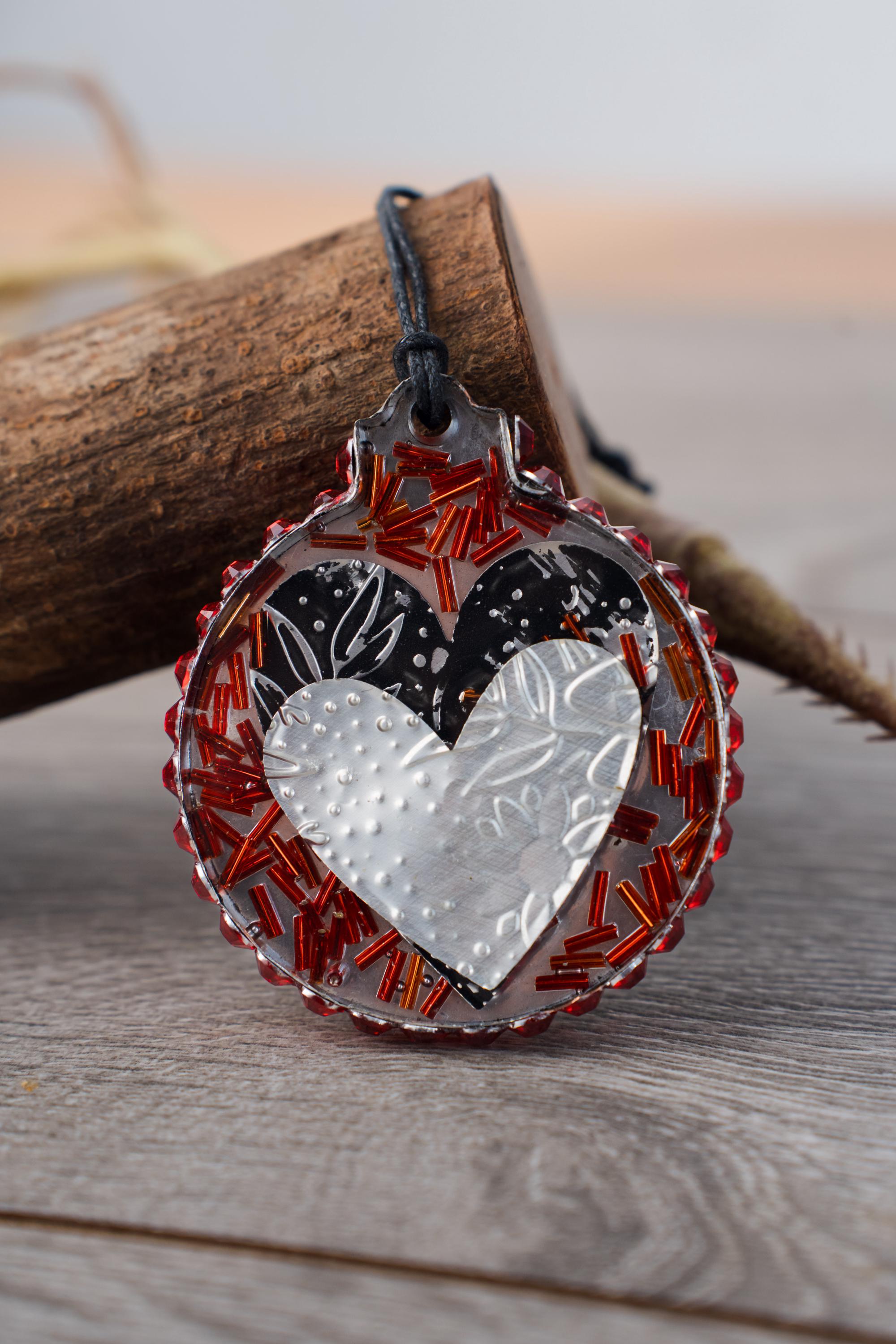 Heart Sisters - Resin ornament featuring handcut embossed hearts from recycled aluminum and a rhinestone halo - Image 1