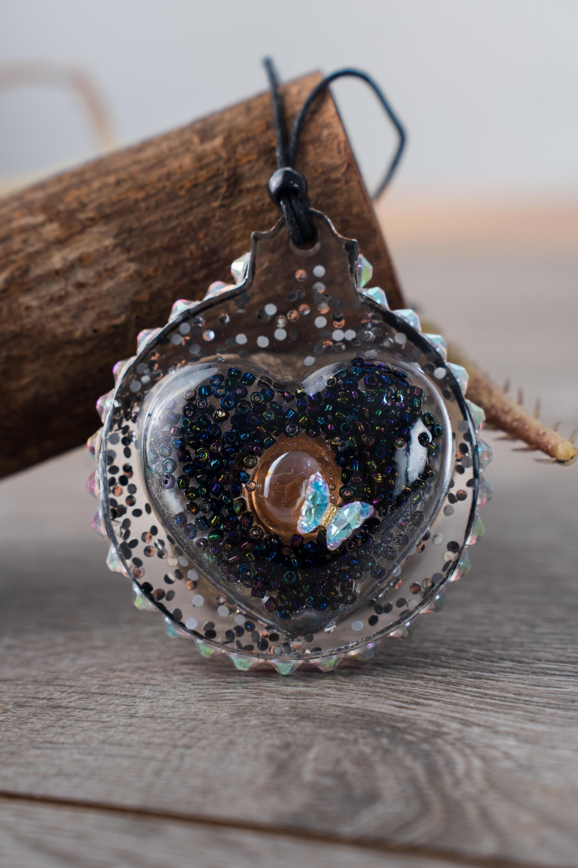 Butterfly Black Heart - Upcycled resin ornament with a handmade cabachon seeds beads, rhinestone halo and a crystal butterfly - Image 1