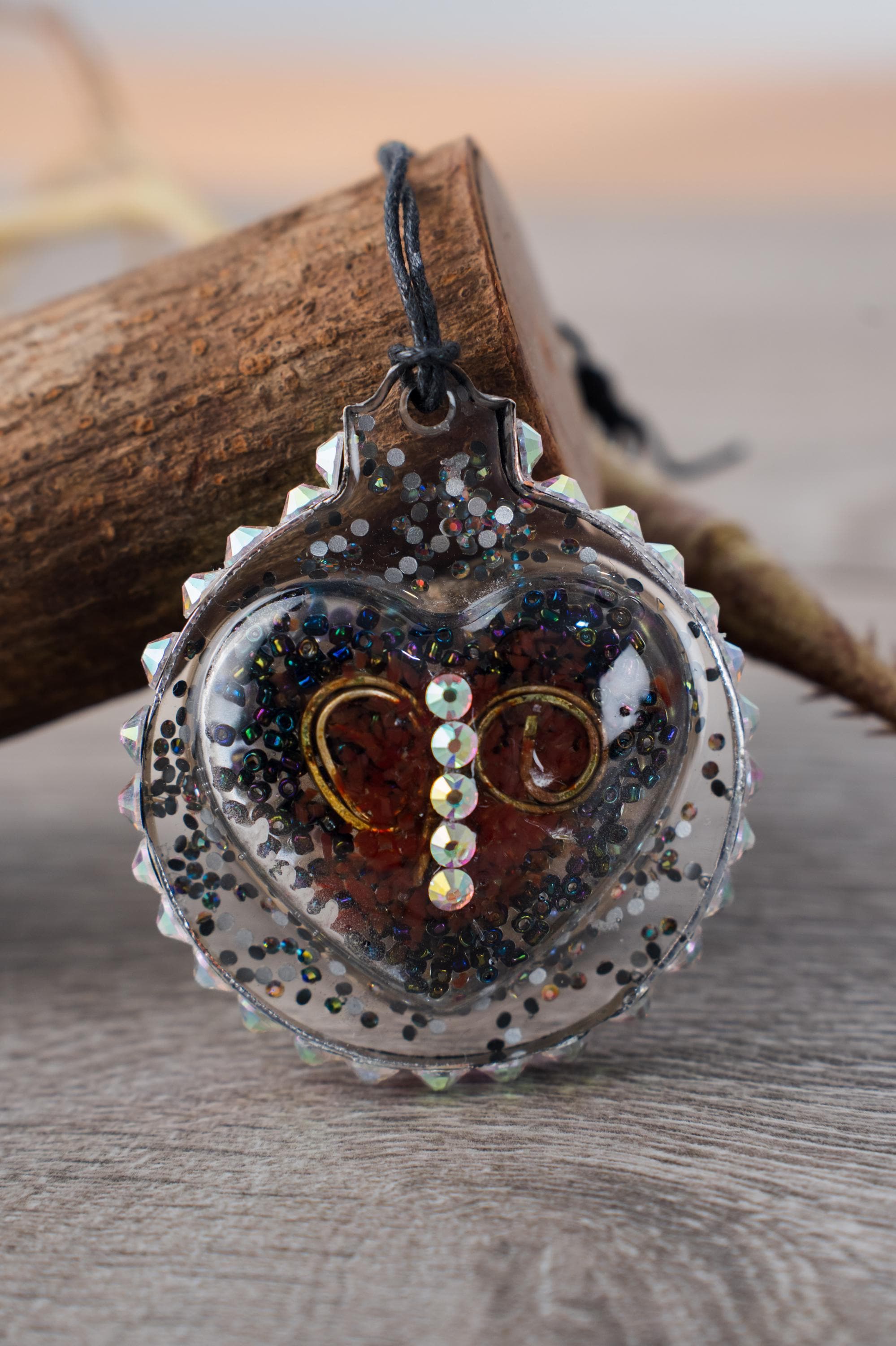 Heart of Nails - Resin ornament with a design featuring curled nails, seed beads and a rhinestone halo - Image 1