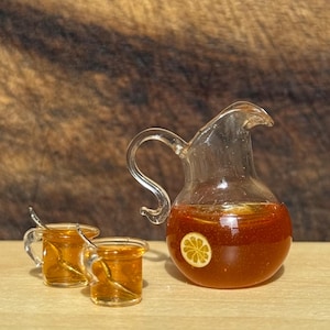 Vintage 1:12 scale dollhouse glass pitcher of iced tea with lemon, and two glasses of iced tea with spoons.