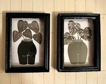 Pair of 1:12 scale whimsical modern boho framed pictures of plant pots  -shaped like the front and back of a naked woman- with green plants