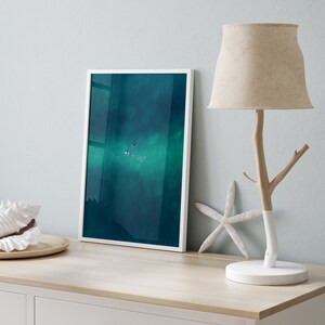 Contemporary side table with a framed photograph of a swimmer in the vast blue sea, paired with a unique tree-branch lamp and coastal decor, creating a tranquil oceanic ambiance.