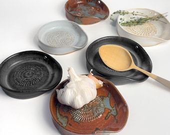 5-in-1 Ceramic garlic/ginger grater, spoon rest, herb stripper, and olive oil dipper