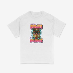 May include: White t-shirt featuring a colourful graphic of a tiki head with the text "Maui Wowie" and "Sativa Hybrid 25% THC High End Euphoria Pineapple Flavor".