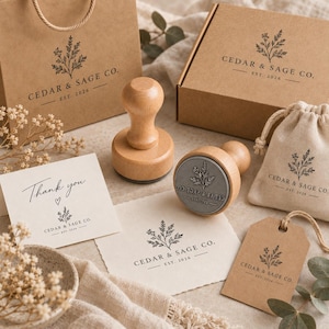 May include: Two wooden rubber stamps with a botanical logo featuring the text CEDAR & SAGE CO. EST. 2026. The set includes a brown paper bag, a cardboard box, a small fabric pouch, a thank you card, and a paper tag, all branded with the same logo.