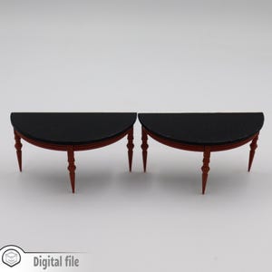 May include: Two black and red half-circle tables with turned legs. The tables are made of wood and have a black top.